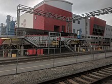 Train with MPI MP36PH-3C locomotive and Nippon Sharyo gallery cars at the Service & Inspection Area; the Shop Building can be seen in the background Caltrain CEMOF, San Jose (40259666613).jpg