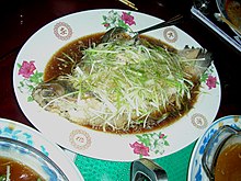 Steamed whole perch with roe inside. Sliced ginger and spring onion is usually spread on top. Chinese Steamed Perch.jpg