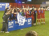 Mills (third from right) and his Tamworth team celebrate winning the Conference North title in the 2008-09 season Conference North Champions 08-09.jpg