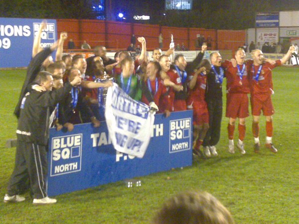 Mills (third from right) and his Tamworth team celebrate winning the Conference North title in the 2008–09 season