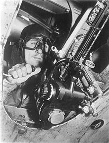 The CSBS Mk. IX mounted in a Fairey Battle. The bomb aimer is sighting through the white ring-shaped backsights to the pin shaped foresights (just visible against the armoured cable) and holding the bomb release switch in his right hand.