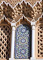 Decorative niches with zellij and carved muqarnas above the gates