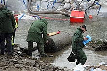 Disposal of a 4,000-pound (1,800 kg) blockbuster bomb dropped by the RAF during World War II. Found in the Rhine near Koblenz, 4 December 2011. A linear shaped charge has been placed on top of the casing Fundort Luftmine 04 Koblenz 2011.jpg