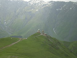 Gergeti Trinity Church in the foreground with the base of Mount Shani in the background.