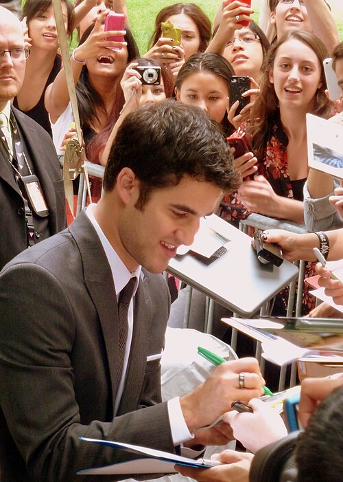 Criss signing autographs during the premiere of Girl Most Likely