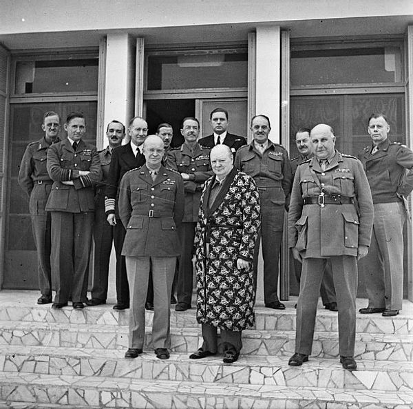 A convalescent Winston Churchill meets the outgoing and incoming Supreme Commanders in the Mediterranean, Dwight D. Eisenhower, to Churchill's right, 