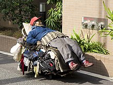 Homeless man lying on a shopping cart in Tokyo Homeless man, Tokyo, 2008.jpg