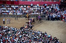 The start of the Palio di Siena, with the release of the canape by the mossiere after the rincorsa (yellow jockey) entered the starting area. Il Palio di Siena luglio 2008 1.jpg