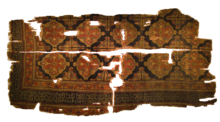 An ancient prayer rug from Konya. Inscriptions in the Mosque of Shah Jalal describe the Sufi leader as a Kanya'i (from Kunya). Some accounts state that Shah Jalal's father was a contemporary of Jalaluddin Rumi. Konya Ethnographical Museum - Carpet 1.png