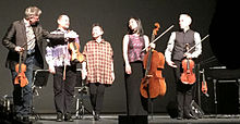 In 2015 with Kronos Quartet, after performing Landfall in Chicago's Harris Theater Laurie Anderson amidst the Kronos Quartet in Chicago after performing LANDFALL 2015-03-17 20.53.41 (16851029595).jpg