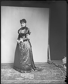 A woman presumed to be Gallaher models a dress from the USNM collections. Louisa Bernie Gallaher Models Dress.jpg