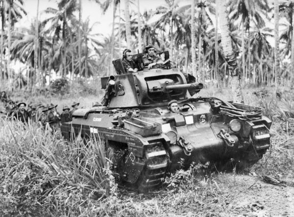 A Matilda tank, named "Clincher", moves towards Japanese strong points near Finschhafen, on 9 November 1943.