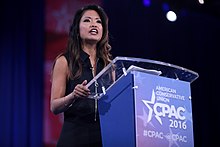 Malkin standing, holding a podium with the CPAC 2016 logo on the front