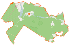 Mapa konturowa gminy Płaska, u góry znajduje się owalna plamka nieco zaostrzona i wystająca na lewo w swoim dolnym rogu z opisem „Jezioro Orle”