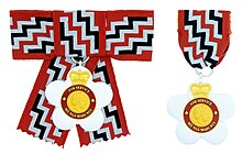 The insignia of the Queen's Service Order from 1975-24