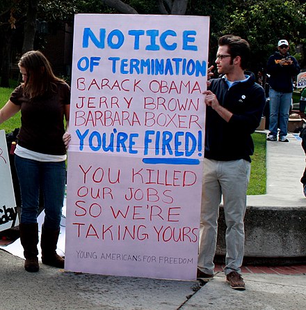 Republican supporter holds a sign criticizing Brown and other Democrats on jobs. Rally (5106111574) (cropped).jpg