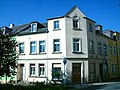 Residential house in semi-open development and corner location, with shop