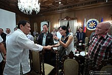 Duterte meets with CPP-NPA secretary-general Wilma and CPP-NPA chairman Benito Tiamzon (foreground, center) on September 26, 2016. Rodrigo Duterte and Wilma Tiamzon.jpg