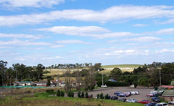 Rooty Hill, seen from the railway station. In the background is the hill from which the area gets its name.