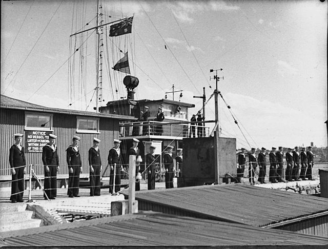 Navy League sea cadets at Schnapper Island with signal staff behind.