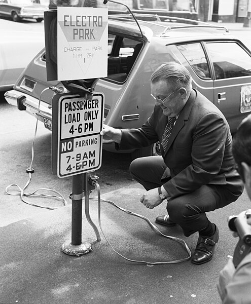 A charging station in Seattle shows an AMC Gremlin, modified to take electric power; it had a range of about 50 miles (80 km) on one charge, 1973