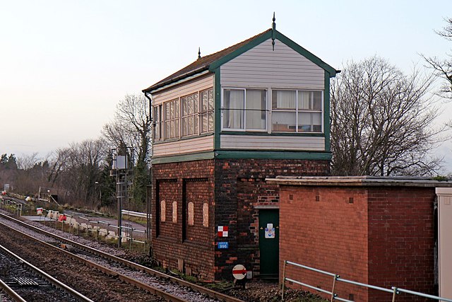 The track engineering works are visible behind the (now abolished) signal box at Huyton, in December 2013.