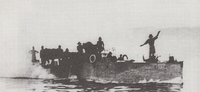 Spicer-Simson (standing) on the Belgian torpedo boat Netta. Spicer-SimsononLakeTanganyika.png