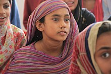 A girl wearing Sossi fabric dress in Sindh. Studying for the chance to become a teacher.jpg