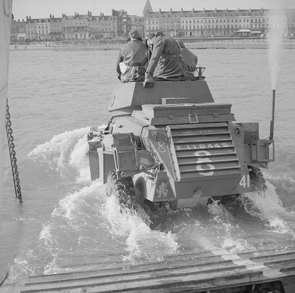 A Humber Armoured Car of 43rd Recce Regiment entering the water from a landing craft during wading trials at Weymouth, Dorset, 5 February 1944.