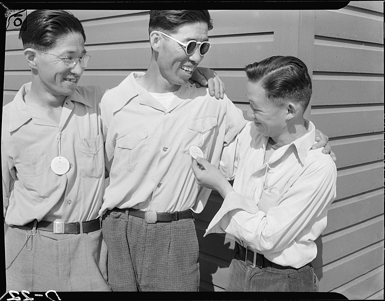 File:Tule Lake Relocation Center, Newell, California. Three evacuee workers exhibit the tags given them . . . - NARA - 538221.jpg