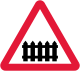 U.K. level crossing with gate or barrier sign.