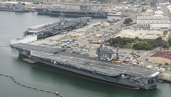 Three US Navy Nimitz-class aircraft carriers, USS Carl Vinson (CVN-70), USS Ronald Reagan (CVN-76), and USS John C. Stennis (CVN-74) pierside at NAS N