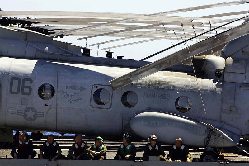 File:US Navy 050114-N-6074Y-099 Sailors assigned to the Air Department aboard the dock landing ship USS Fort McHenry (LSD 43) sit in shade made by Marine Corps CH-46 Sea Knight helicopters on the flight deck during an underway reple.jpg