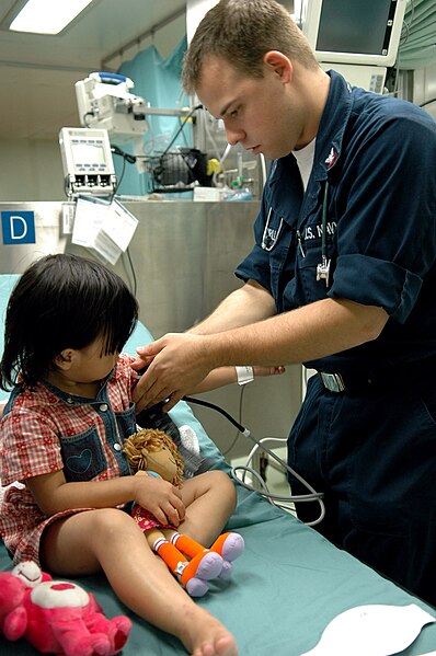 File:US Navy 060603-N-3714J-017 Navy Hospital Corpsman 3rd Class Marcus Ferrill, of Cameron, Calif., takes a child's blood pressure.jpg