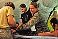 US Navy 090908-N-4010S-004 Major Shannon Faber and Capt. Natalie Boldauff checks the status of a patient during an examination.jpg