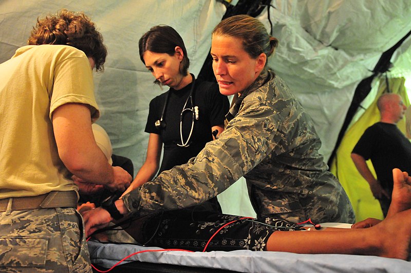 File:US Navy 090908-N-4010S-004 Major Shannon Faber and Capt. Natalie Boldauff checks the status of a patient during an examination.jpg