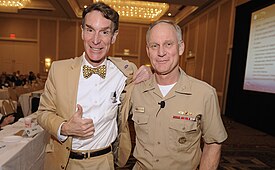 Chief of Naval Research Nevin Carr with Bill Nye in 2011. Nye had just excitedly accepted an ONR pocket protector presented by Carr. US Navy 110505-N-PO203-205 Bill Nye stands with the Chief of Naval Research Rear. Adm. Nevin Carr following the presentation of a powered by Naval.jpg