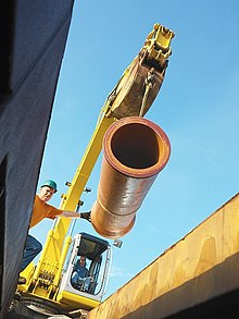 Bell & Spigot Pipe manufactured in the U.S. going into the trench VCP Install.jpg