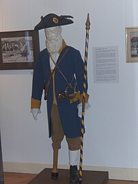 Le messager boiteux, présent depuis 1927. Costume de Samuel Burnand qui le personnifia en 1955 et 1977.