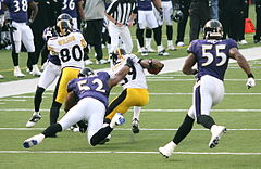 Lewis (#52) brings down Willie Parker in a game against the Pittsburgh Steelers, 2006 Willie Parker and Cedric Wilson.jpg
