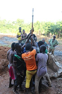 Workers and people from the nearby town helping repair a water borehole in Ghana Workers and Volunteers helping out.jpg