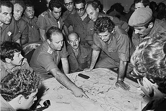 Consultation at Northern Command, October 10, 1973.
Head of Northern Command Yitzhak Hofi is pointing at the map, while IDF Chief of Staff David Elazar is leaning on the map with both hands Yom Kippur War (G-1-4063-dTS).jpg