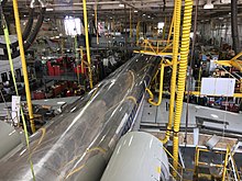 A hangar for single aisle aircraft repair at the American Airlines Maintenance Base at Tulsa International Airport. An MD-80 being worked on next to a Boeing 737