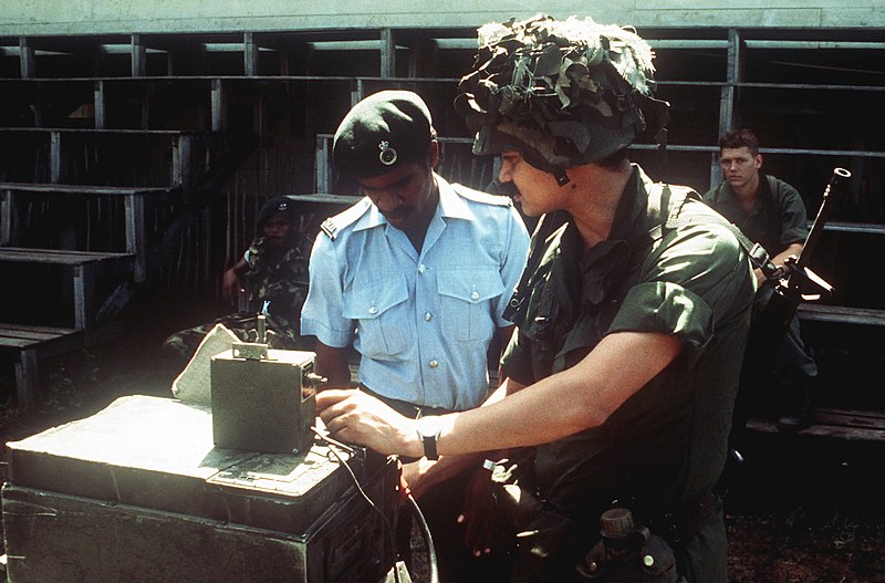 File:A member of the 82nd Airborne Division operates communications equipment while a member of the Eastern Caribbean Defense Force looks on during Operation URGENT FURY - DPLA - 5a2f4b975884db6d39069034a6aecaad.jpeg