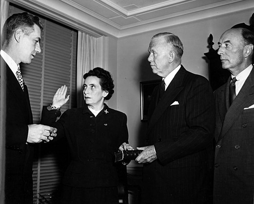 Anna M. Rosenberg being sworn in as Assistant Secretary of Defense by Felix Larkin (left), General Counsel of the Department of Defense. General George Marshall (second from right) and Robert A. Lovett (right), Deputy Secretary of Defense, witness. November 15, 1950.