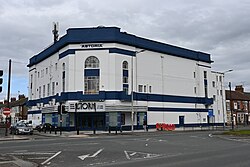 The Astoria Bingo Club, a former cinema converted into a bingo club, on Holderness Road in Kingston upon Hull. The building has recently received a repaint, painting the building into white and adding new dark blue accents around the building.