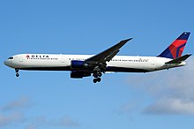 Twin-engine airliner with landing gear and flaps extended