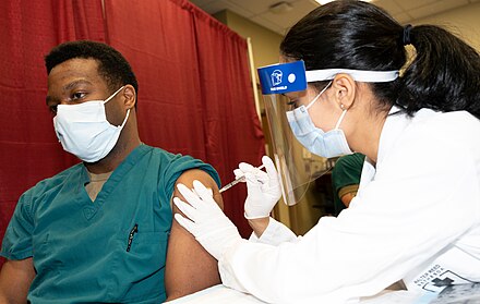 A doctor at Walter Reed National Military Medical Center receiving a COVID-19 vaccination in December 2020
