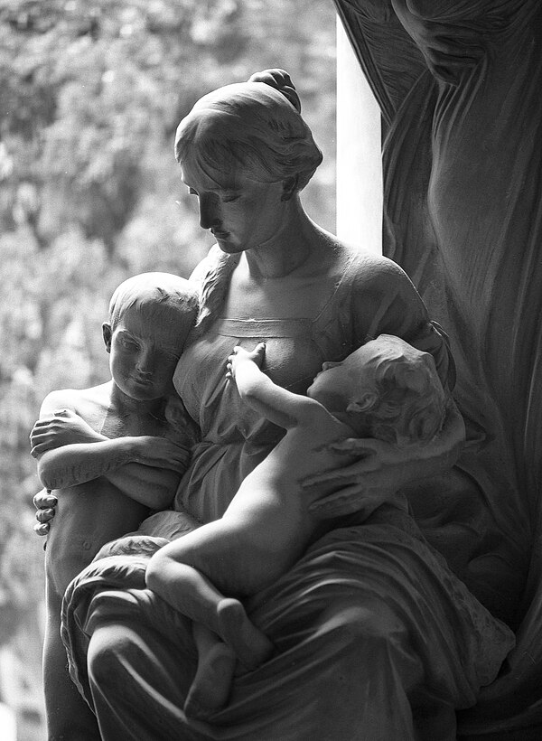 Statue of a mother with children at the Monumental Cemetery of Staglieno in Genoa