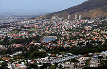 The City Bowl with the suburbs of Devil's Peak Estate, Vredehoek (and the three Disa Park towers in the background), Oranjezicht and The Gardens, with Molteno Dam in the foreground.